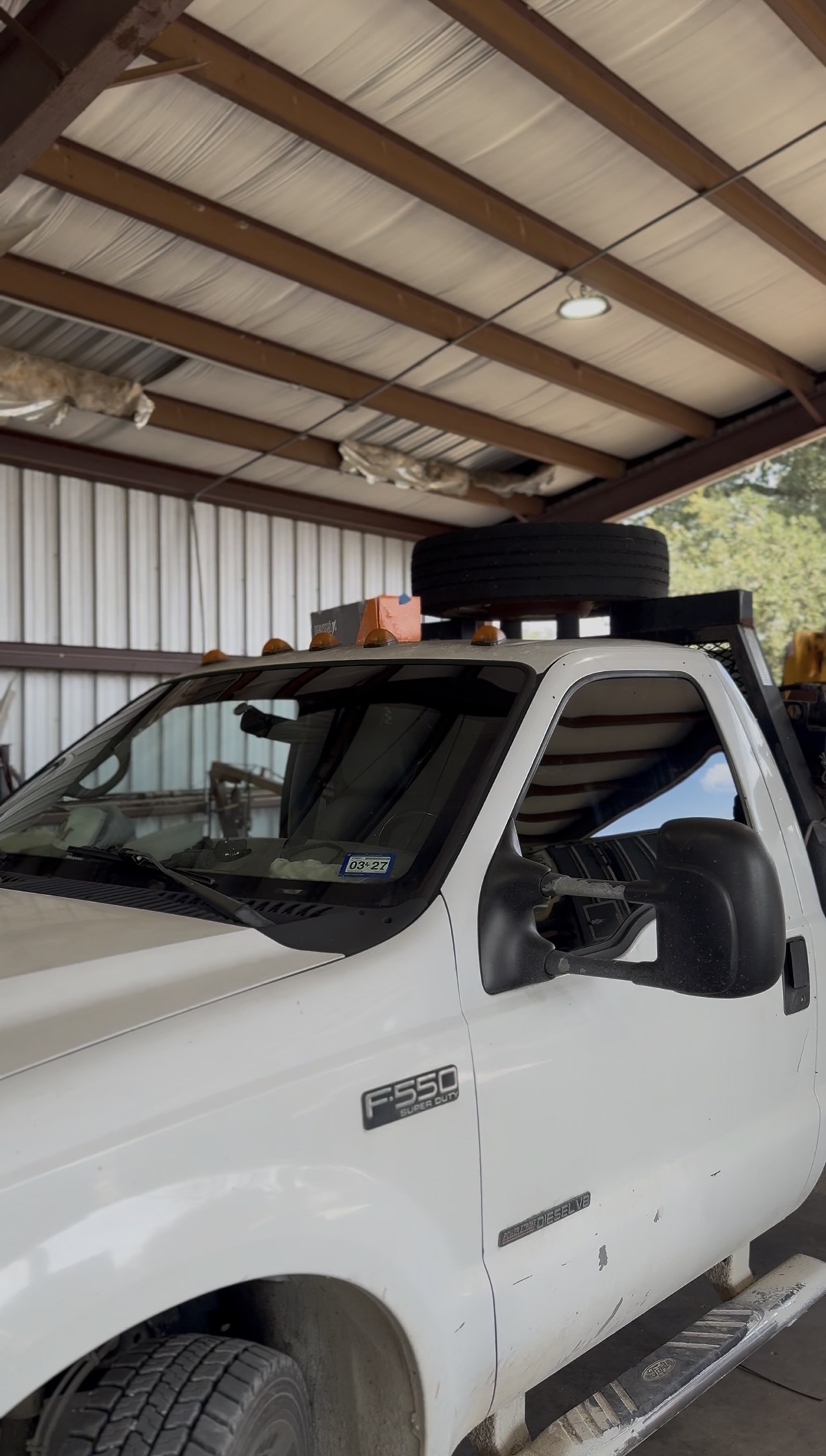 White Ford F-550 work truck with tinted windows