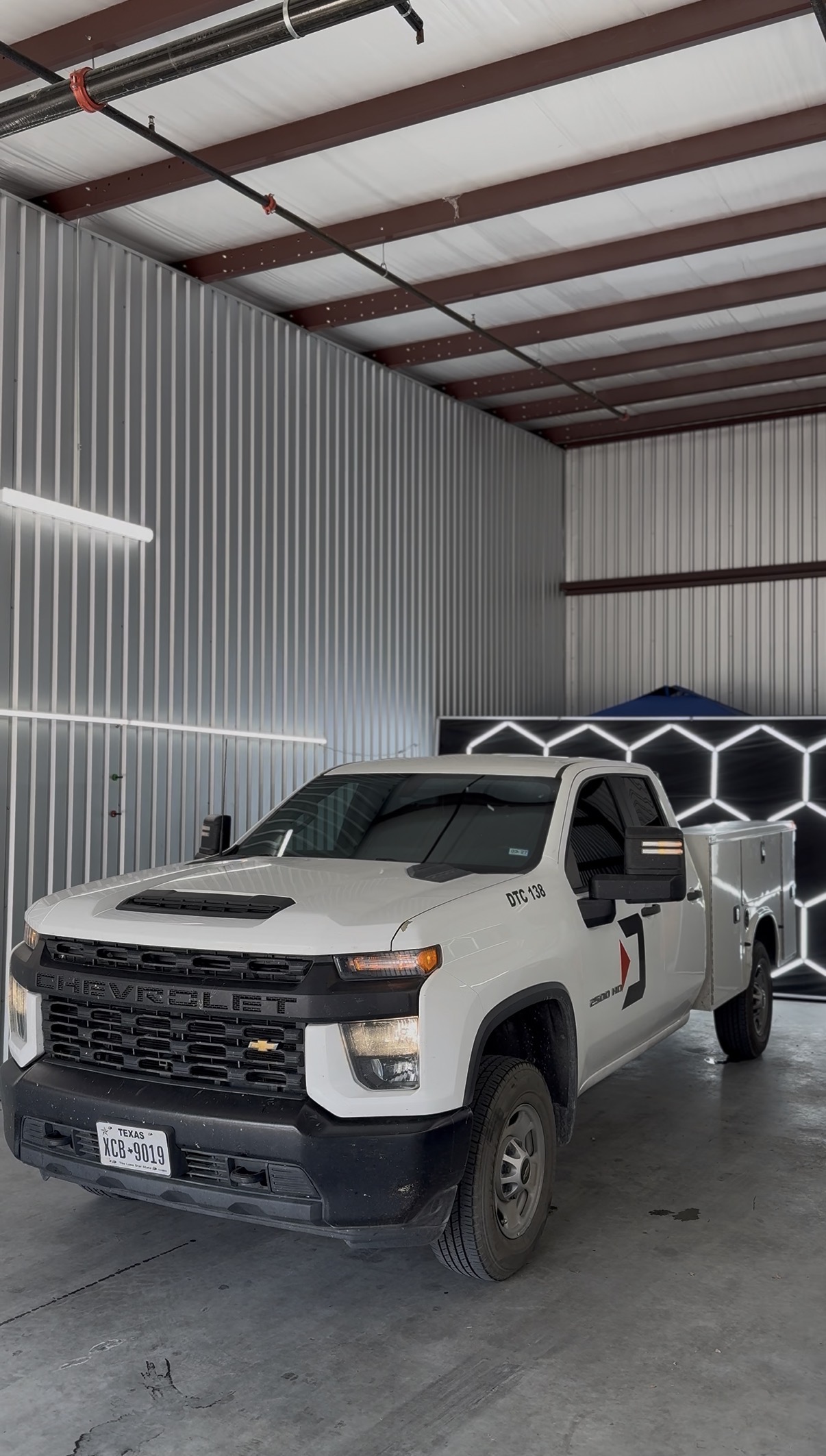 White Chevrolet 3500 HD utility truck with tinted windows