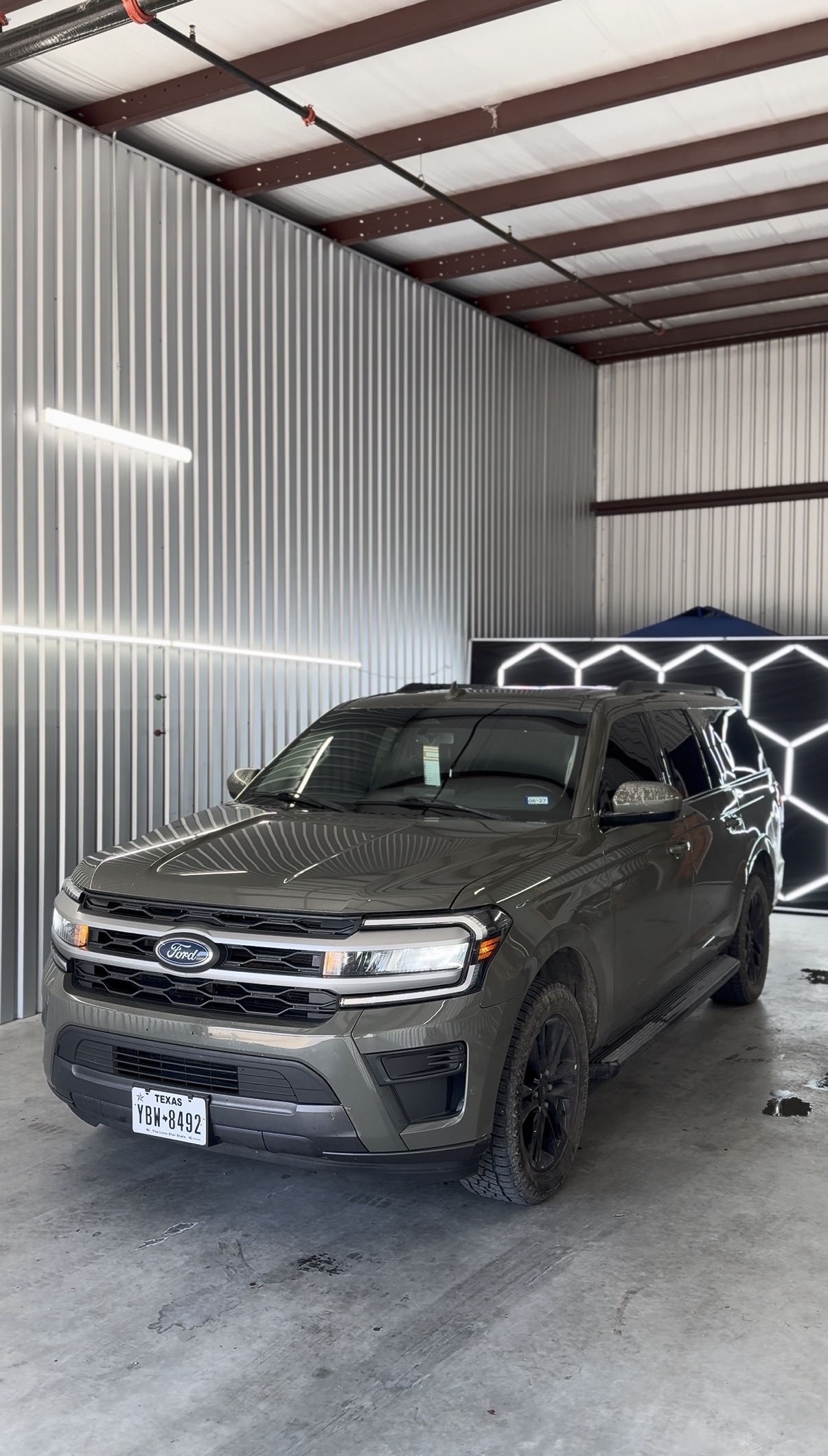 Gray Ford pickup with tinted windows inside the shop