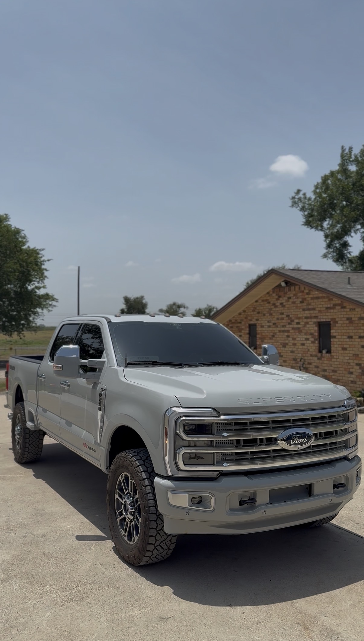 White Ford F-250 with tinted windows at a job site