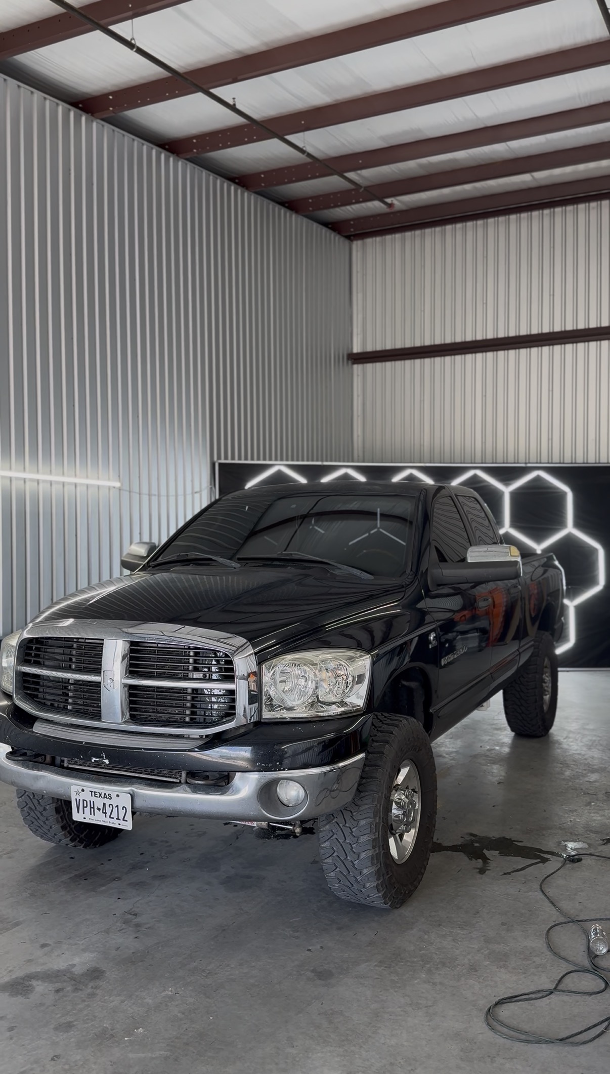 Black Ram truck with tinted windows inside the shop