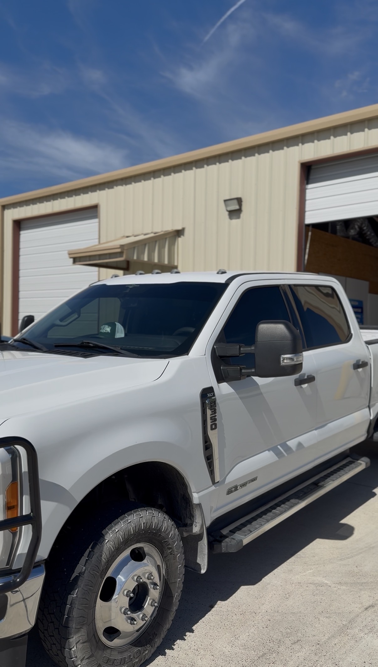White Ford Super Duty service truck with tinted windows