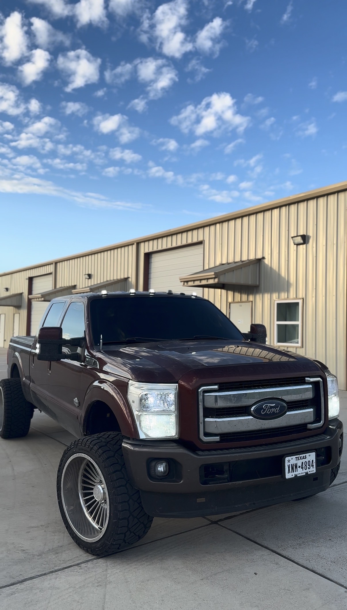 Lifted maroon Ford F-250 with tinted windows