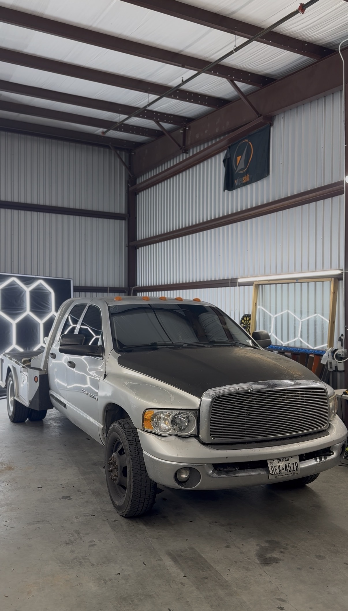Silver Ram flatbed truck with tinted windows