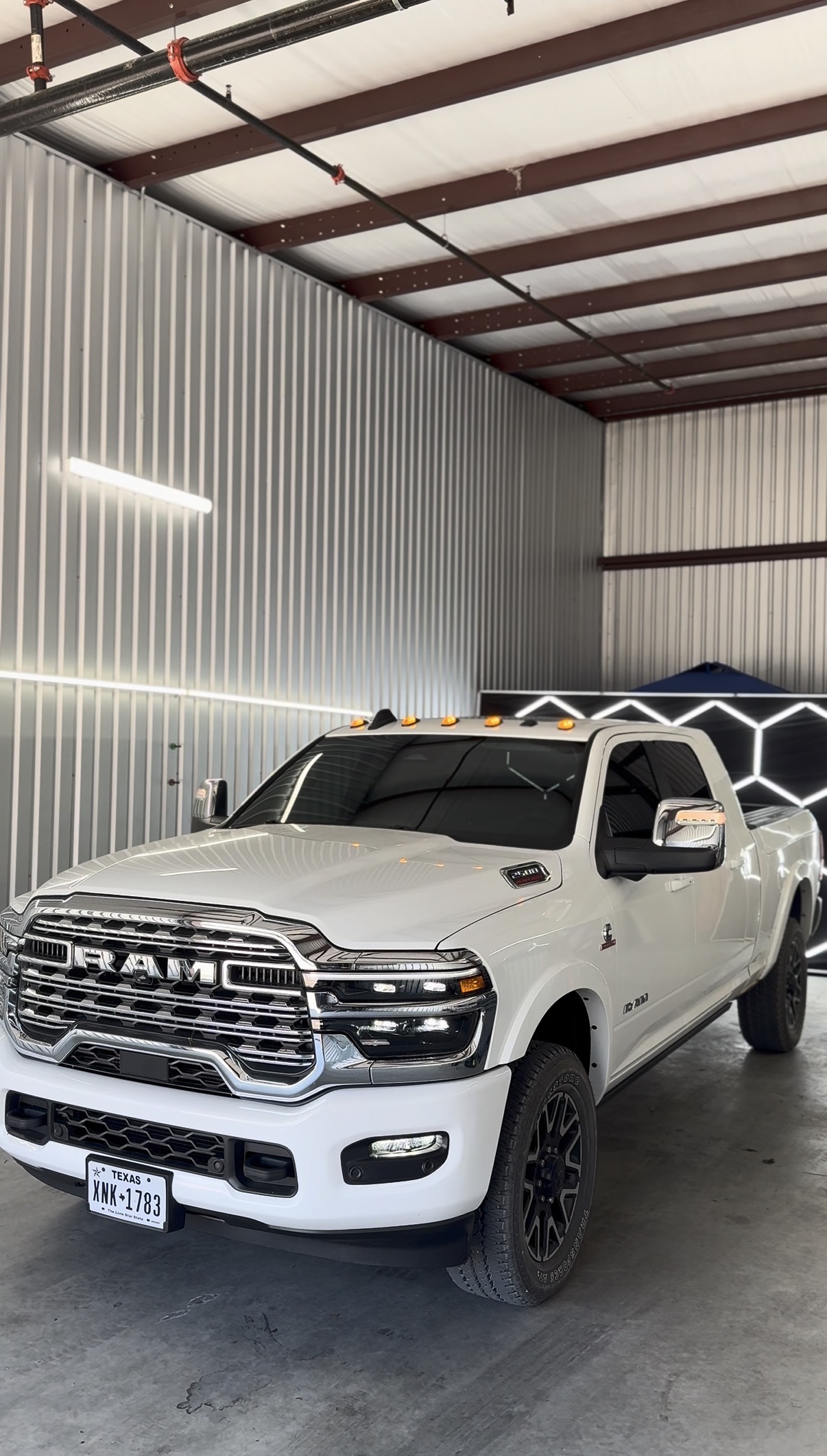 White Ram truck with tinted windows inside the shop