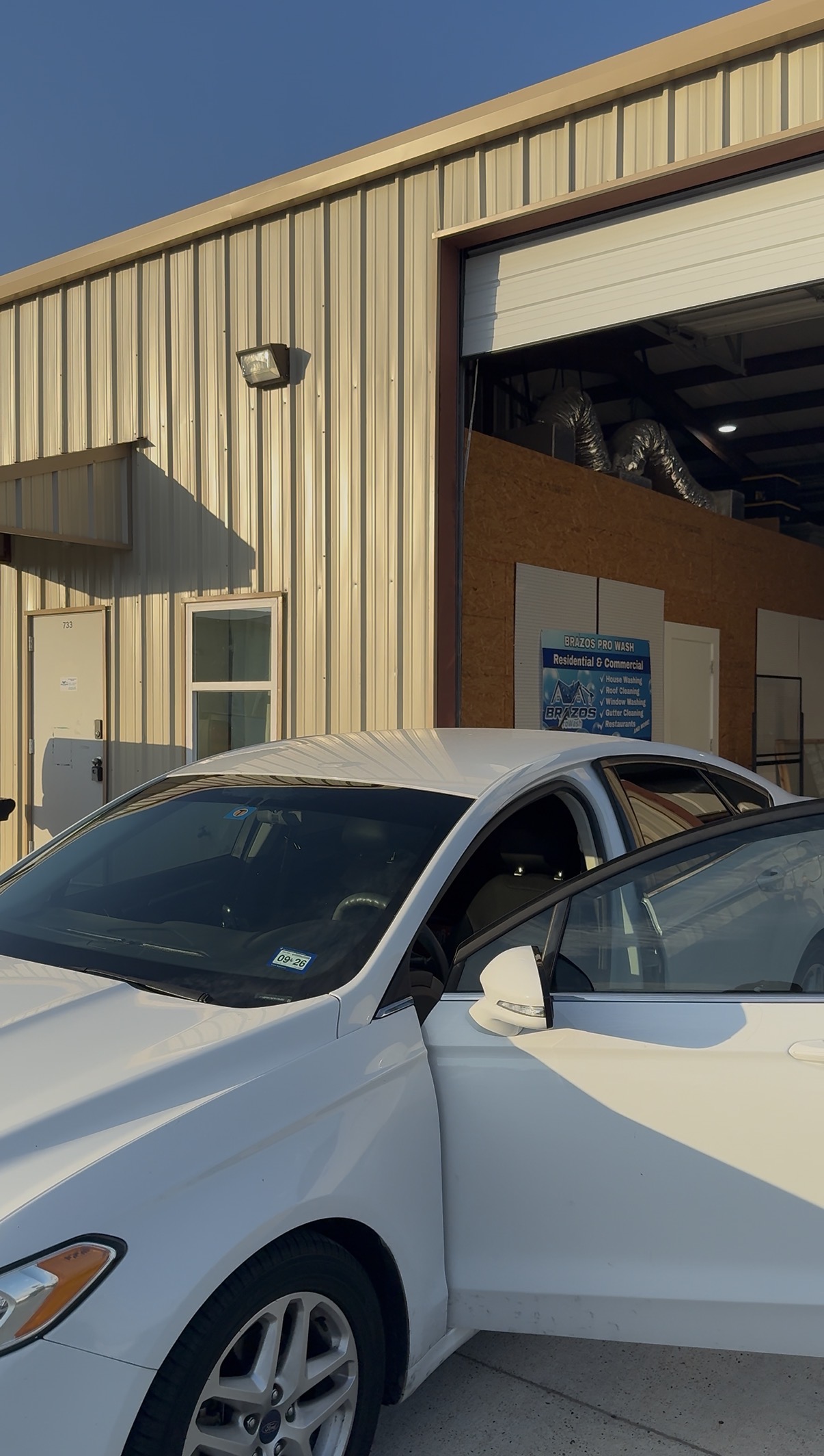 White car with tinted windows at the shop